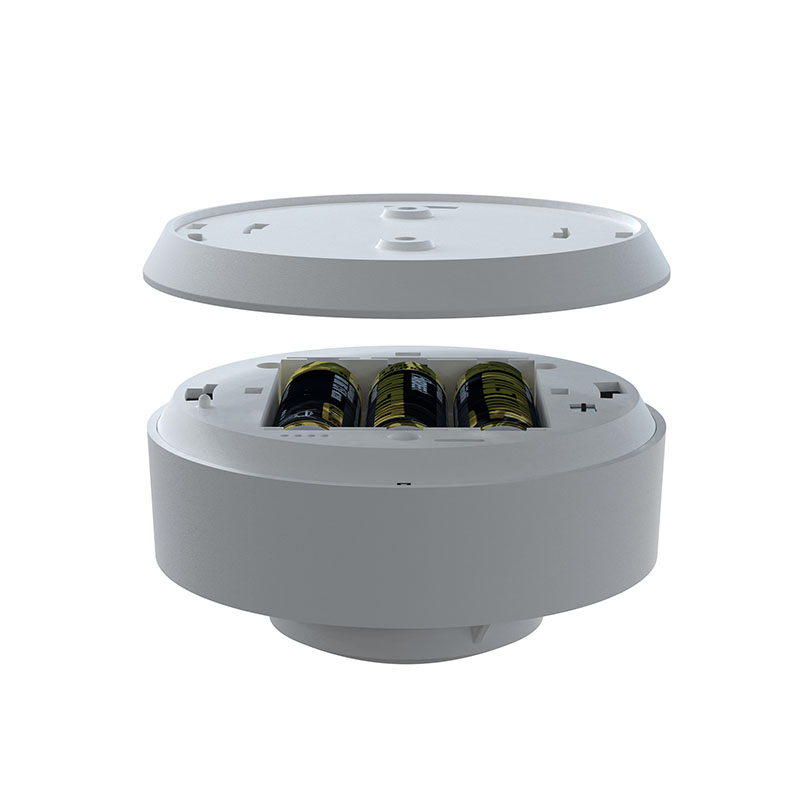 Smart Smoke Alarm battery compartment with three AA batteries neatly arranged, showcasing the device’s sleek design and easy-to-access power source.