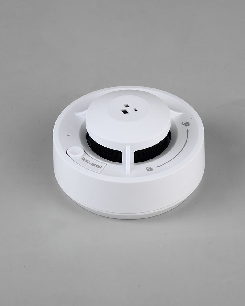 Smart Smoke Alarm with a sleek white design, featuring a test button and a hush function, ensuring reliable fire safety and convenience.